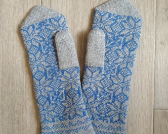 May include: A pair of gray knitted mittens with a blue snowflake pattern.