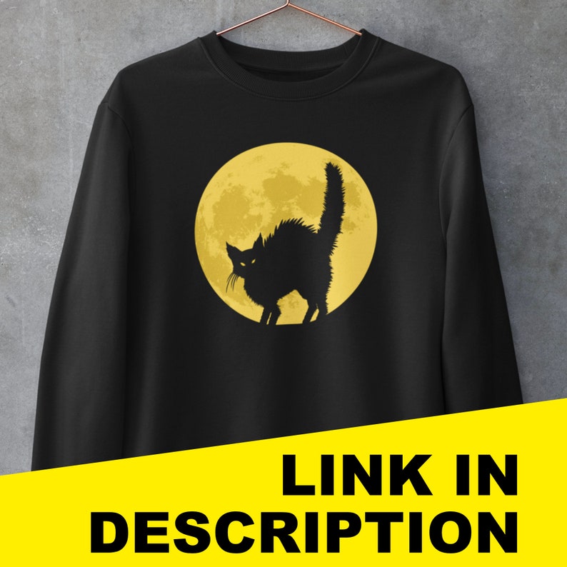 May include: Black sweatshirt with a graphic of a black cat silhouetted against a yellow full moon.