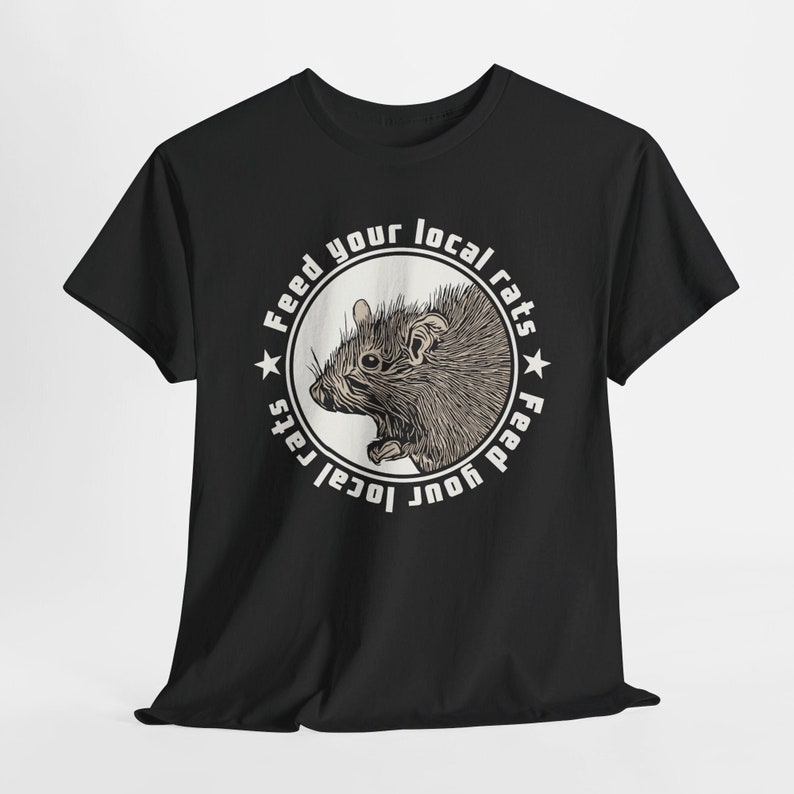 Black t-shirt featuring a circular design with an illustrated rat in the center, encircled by the phrase Feed your local rats. The design has a vintage punk aesthetic with cream coloured accents, standing out sharply against the black background