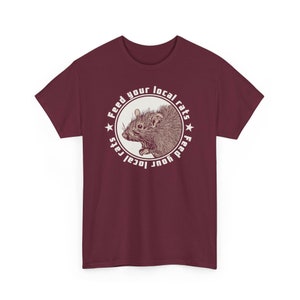 May include: Burgundy t-shirt with a white circle graphic featuring a rat and the text "Feed your local rats Feed your local rats".