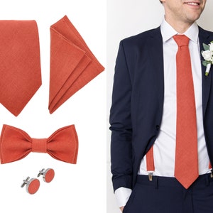 Aurora red color linen man suit accessories: Tie, cufflinks, pocket square, Bow tie. On the right, the front-view model with a suit wears the same aurora red color linen necktie, pocket square, and linen suspenders with clips.