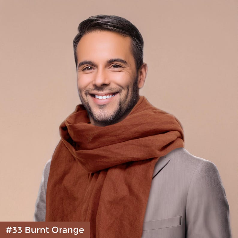 May include: A man wearing a burnt orange scarf over a gray suit jacket. The scarf is folded and draped around his neck. #33 Burnt Orange
