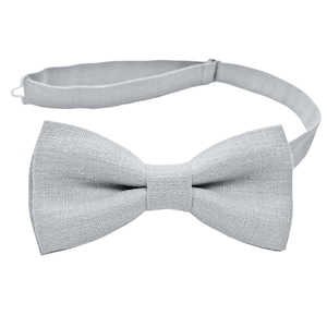 May include: A gray bow tie made of linen fabric with an adjustable strap.