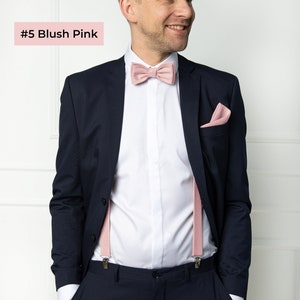 The front-view model wears a blush pink color linen bow tie, cufflinks, pocket square, and blush pink color linen suspenders with clips.