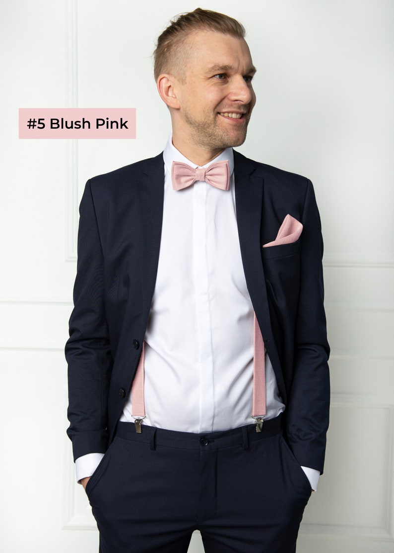 The front-view model wears a blush pink color linen bow tie, cufflinks, pocket square, and blush pink color linen suspenders with clips.