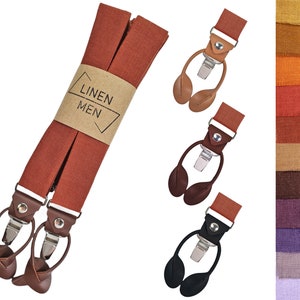 Puede incluir: Un juego de tirantes de lino marrón con detalles de cuero y clips metálicos. Los tirantes tienen una etiqueta que dice "LINEN MEN".