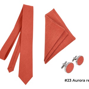 Aurora Red color linen wrapped necktie, metal cufflinks with aurora red color linen detail in the middle, and folded pocket square.