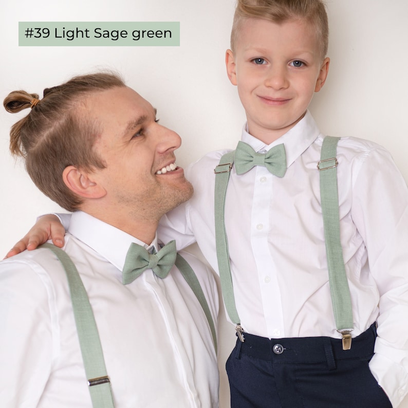 Father and son wearing the same style of Light sage green color linen bow ties and light sage green color linen suspenders with clips.