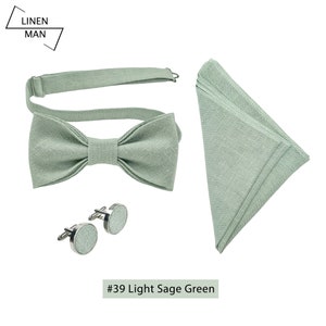 Light sage green color linen pre-tied bow tie. The bow tie has an attached adjustable strap. Cufflinks, are made of silver color metal and have a light sage green color linen detail in the middle. Light sage green color linen folded pocket square.