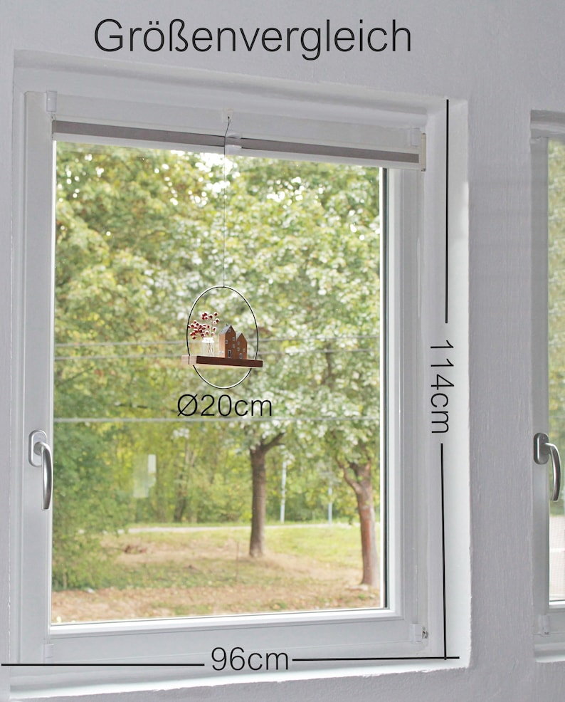 May include: A hanging window decoration featuring a circular metal frame with a diameter of 20 cm, holding a small wooden house and a glass vase with red berries. The window frame is labeled with dimensions of 114 cm by 96 cm.