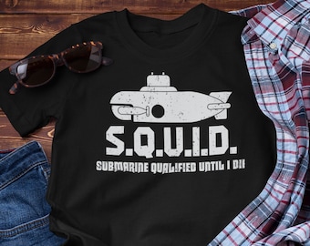 May include: Black t-shirt with a white graphic of a submarine and the text "S.Q.U.I.D. Submarine Qualified Until I Die."