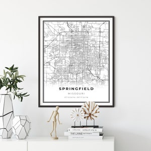 May include: Black and white printable map of Springfield, Missouri with the city name and coordinates "37°12'55" N | 93°17'54" W" printed below the map.