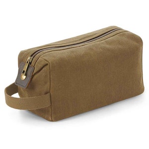 May include: A brown canvas zippered wash bag with a leather handle and a brass zipper pull.