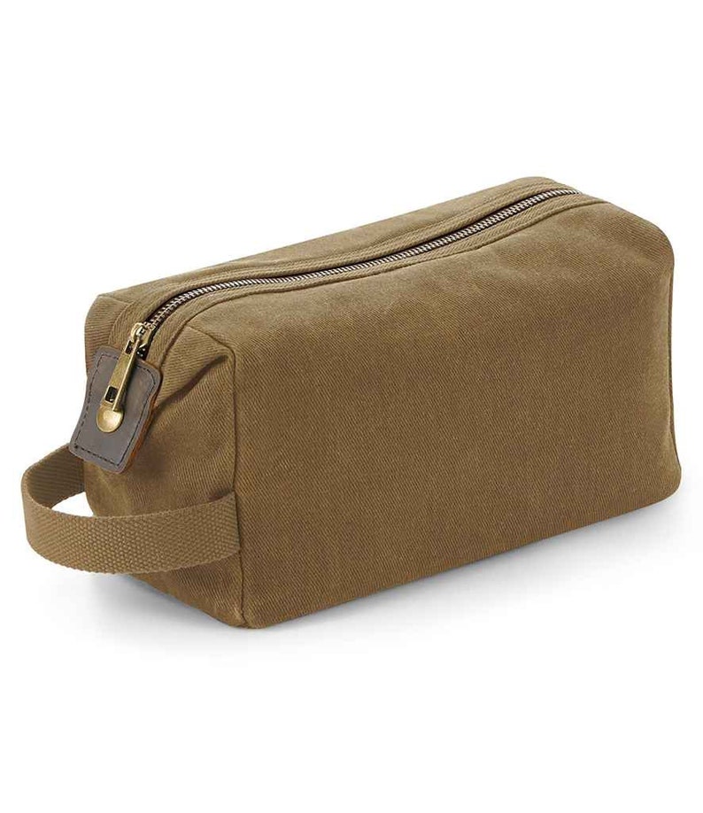 May include: A brown canvas zippered wash bag with a leather handle and a brass zipper pull.