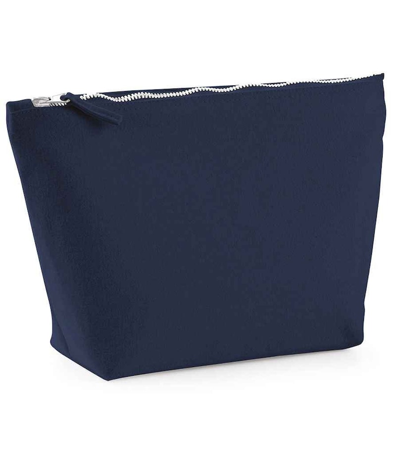May include: A dark blue zippered pouch or cosmetic bag made of a soft, textured fabric.