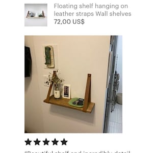 May include: A wooden shelf with leather straps hanging on a white wall. The shelf is 72.00 US$ and is described as "Beautiful shelf and incredibly detail-oriented packaging!! This is exactly what I was looking for."