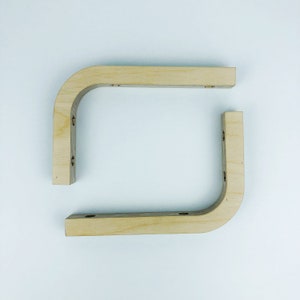 May include: Two unfinished wooden corner brackets, each with four pre-drilled holes for mounting.