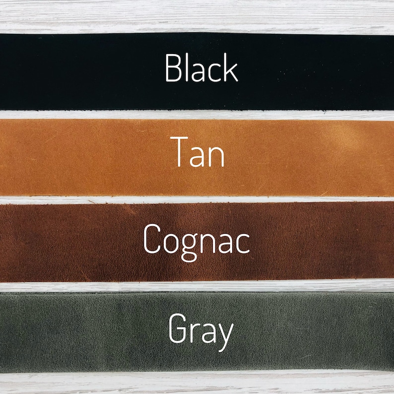 May include: Four leather straps in different colors: black, tan, cognac, and gray. The straps are arranged horizontally, with the black strap at the top and the gray strap at the bottom.