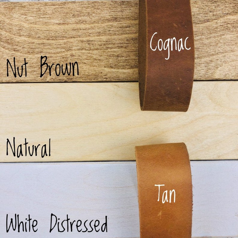 May include: Four leather straps in different colors: Nut Brown, Cognac, Natural, and Tan. The straps are displayed on a wooden surface.