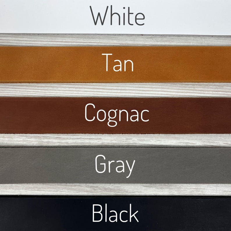 May include: Five leather swatches in different colors: white, tan, cognac, gray, and black.