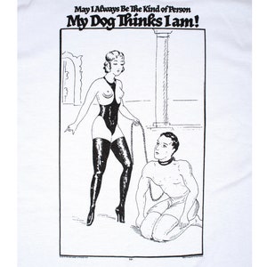 May include: Black and white illustration of a woman in a leotard and thigh-high boots holding a chain leash attached to a man kneeling on the floor. The text above them reads "May I Always Be The Kind of Person My Dog Thinks I Am!"