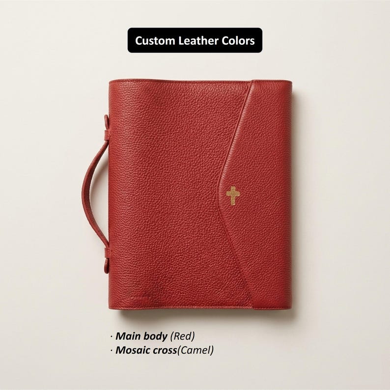 May include: Red leather Bible cover with a camel-colored cross emblem. The cover has a handle and a flap closure. The text "Custom Leather Colors" is at the top, with "Main body (Red)" and "Mosaic cross (Camel)" at the bottom.