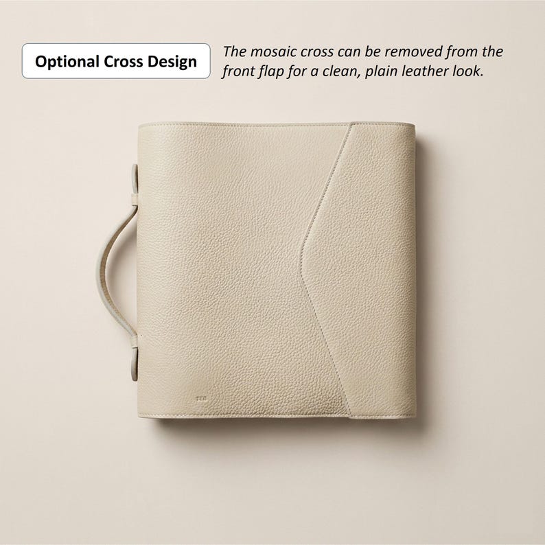 May include: A cream-colored leather portfolio with a handle and a flap. The text "Optional Cross Design" and "The mosaic cross can be removed from the front flap for a clean, plain leather look" are visible. The portfolio has a textured surface.