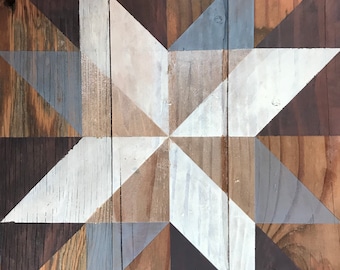 May include: A wooden wall art piece with a geometric star design in shades of brown, gray, and white.