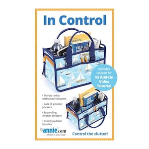 May include: A blue and white fabric tote bag with a sailboat pattern. The bag has a zippered pocket, a handle, and a removable strap. The bag is filled with various items, including a book, a water bottle, and a remote control. The text "In Control" is at the top of the image. The text "Control the clutter!" is at the bottom of the image. The text "by annie.com" is in the lower left corner of the image. The text "Includes coupon for $5 Add-On Video Tutorial" is in the lower right corner of the image.