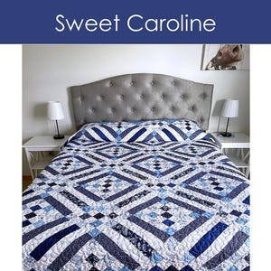 May include: A blue and white quilt with a geometric pattern covers a bed. The quilt features diamond and stripe designs in various shades of blue and white. The text "Sweet Caroline" is at the top. The quilt is available in throw, twin, queen, and king sizes.