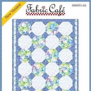 May include: A quilting pattern for a "Snowball" quilt, featuring a white background with blue octagons and a floral print. The pattern is from Fabric Cafe and is a new version. The finished quilt measures 43 1/2 inches by 57 inches and can be made with 3 yards of fabric.