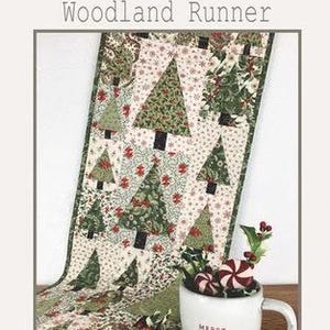May include: A festive Christmas table runner with a woodland theme. The runner features a pattern of green Christmas trees on a cream background, with red floral accents. The runner measures 14 inches by 54.5 inches.