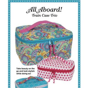 May include: A trio of train cases in various sizes, featuring colorful paisley and polka dot patterns. The largest case has a pink handle and teal zipper, while the smaller ones have coordinating designs. The text "All Aboard! Train Case Trio" is at the top.