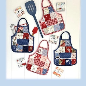 May include: Image of a set of patchwork apron-shaped hot pads with red, white, and blue fabrics. The hot pads are approximately 9 inches high and 8 inches wide. A blue spatula and small cards are also in the image. The text "Apron Hot Pads" is at the top.