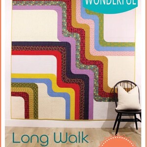 May include: A colorful quilt pattern called "Long Walk" with a geometric design of curved lines in shades of red, yellow, blue, green, and purple. The quilt is hanging on a white wall above a wooden floor. The text "Sew Kind of WONDERFUL" and "WCR Pattern" are also visible in the image.