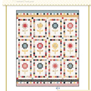 May include: A colorful quilt pattern featuring stylized sunflowers in red, yellow, and blue. The quilt has a white background with a grid pattern and is bordered with patterned fabric. The text "afternoon tea" is visible.