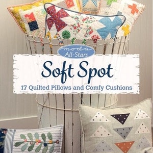 May include: A book titled "Soft Spot" with a white background and a colourful image of 17 quilted pillows and comfy cushions. The book is part of the Moda All-Stars series.