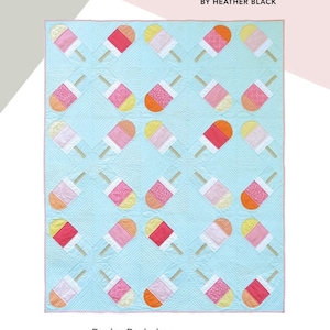 May include: A light blue quilt featuring a pattern of colorful popsicle shapes. The quilt, measuring 60 x 72 inches, has a pink border and is labeled "Busby Berkeley Popsicles" by Quiltachusetts.