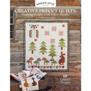 May include: A quilt with a nature-themed design featuring an owl, trees, mushrooms, and a rabbit. The quilt is bordered with a black and brown pattern. The text "CREATIVE PRECUT QUILTS" and "10 Colorful Designs" are visible.