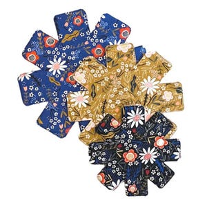 May include: Three floral print pot holders in blue, yellow, and black. Each pot holder is shaped like a star with eight points.