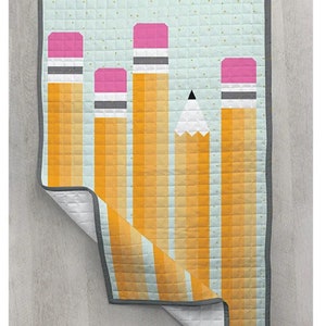 May include: A quilt featuring a design of yellow and orange pencils with pink erasers on a light blue background with small white dots.