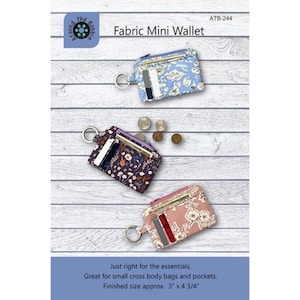 May include: Three fabric mini wallets with key rings, featuring floral patterns in light blue, dark purple, and dusty pink. Each wallet has card slots and a zipper closure. Text includes 'Fabric Mini Wallet', 'ATB-244', and 'Finished size approx. 3" x 4 3/4".'