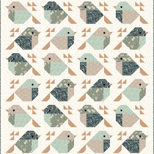 May include: A patchwork quilt with a repeating pattern of geometric birds. The birds are in shades of blue, green, and tan, with floral details. The background is cream, and the quilt has a brown border. The quilt is likely made of cotton.