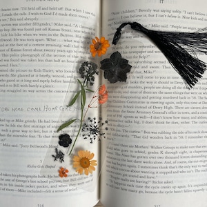 Laminated Orange and Black Pressed Flower Bookmark with Tassel - Spooky Bookish Decor - Halloween Inspired Floral Artwork - Gift for Readers