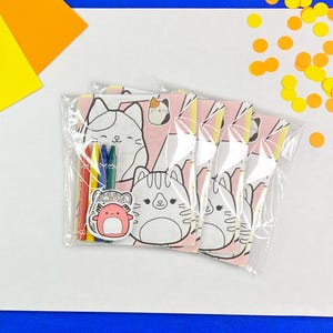 May include: A set of four colouring pages featuring cute cat illustrations. The pages are packaged in a clear plastic bag with four crayons.