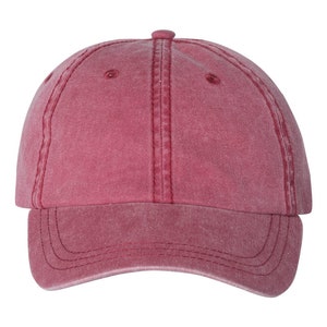 May include: A red baseball cap with a slightly distressed look. The cap has a curved brim and a structured crown.
