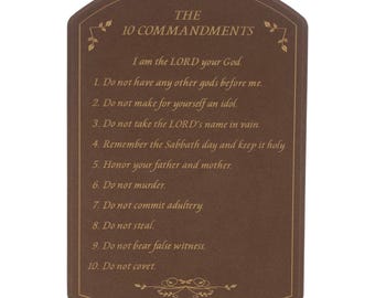 May include: A brown plaque with rounded edges displays "THE 10 COMMANDMENTS" in gold lettering. The text of the commandments is also in gold. Decorative floral accents are at the top and bottom of the plaque.