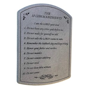 May include: A gray stone plaque with the text "THE 10 COMMANDMENTS" and the Ten Commandments listed below. The plaque has a curved top and decorative floral accents.