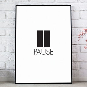 May include: A black framed poster with a white background and the word "PAUSE" in black text. The poster features two black vertical bars with a small space between them.