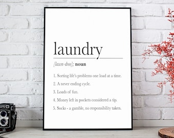 May include: A black and white printable wall art print with the word "laundry" defined as "sorting life's problems one load at a time", "a never ending cycle", "loads of fun", "money left in pockets considered a tip", and "socks - a gamble, no responsibility taken".